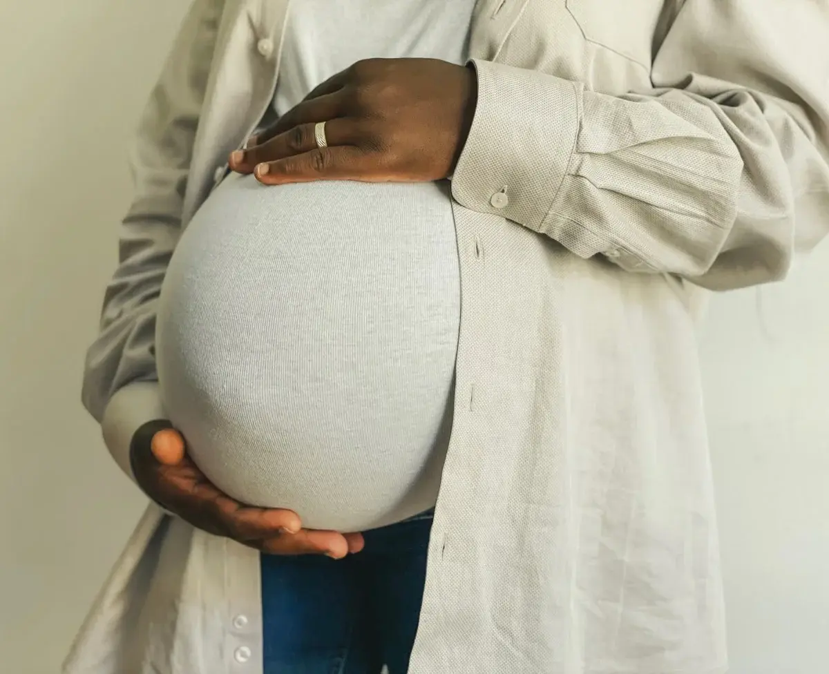 Pregnant woman holding her belly